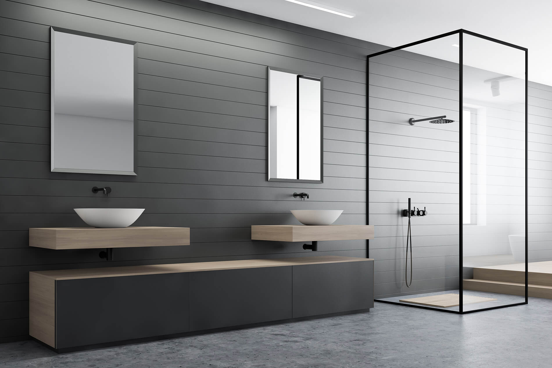 Dark-tiled bathroom with wall-hung vanities and a frameless glass shower