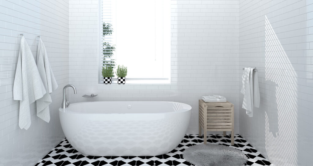 White tiled bathroom with a freestanding bathtub and patterned floor tiles