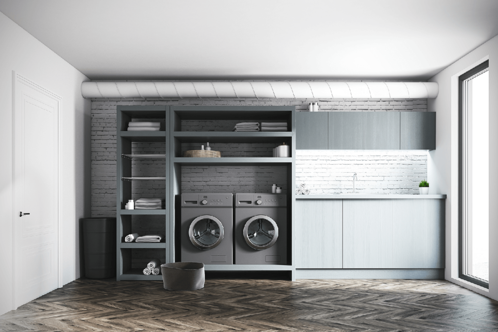 Laundry room with dark cabinetry, open shelving, and a side-by-side washer and dryer