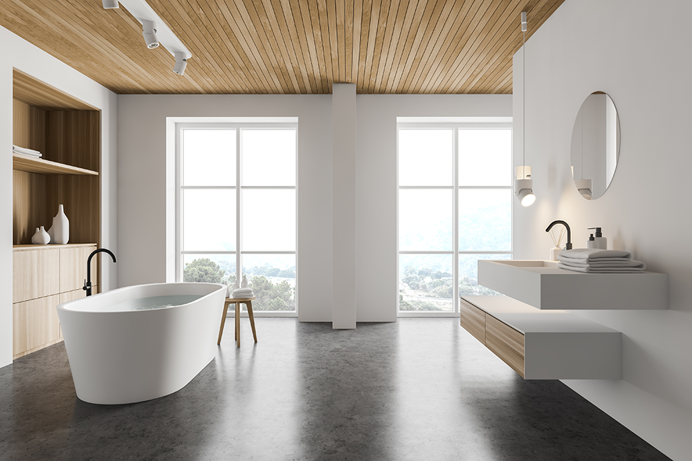 Freestanding bathtub in a bright bathroom with a timber ceiling and floor-to-ceiling windows